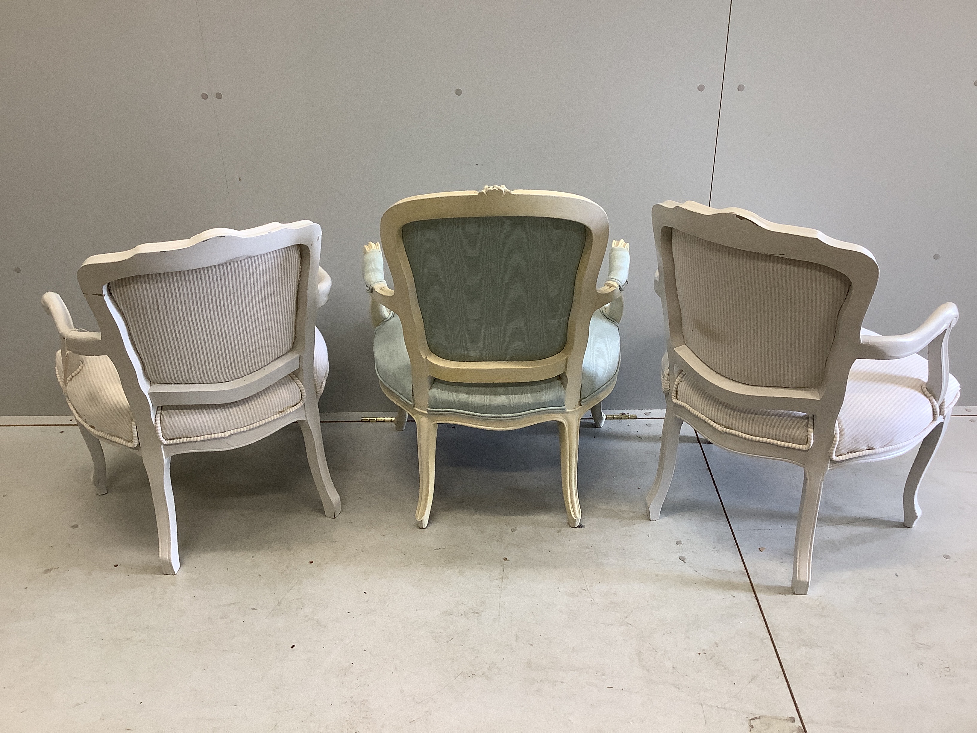 A pair of French style painted fauteuil, width 58cm, depth 48cm, height 80cm together with one other similar chair